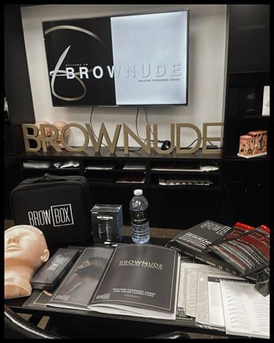 Training setup at Brownude Academy with tools and materials for permanent makeup.